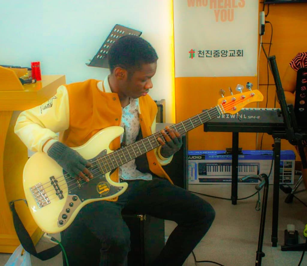 Francis playing bass guitar at a church studio