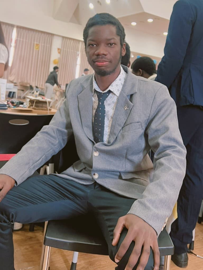 Francis seated at the KDU Global Smart Computing exhibition, 2026