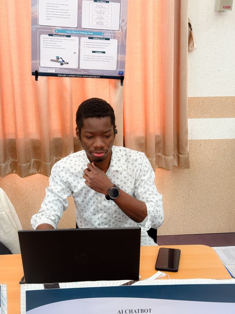 Francis working on his laptop during the KDU Global exhibition setup